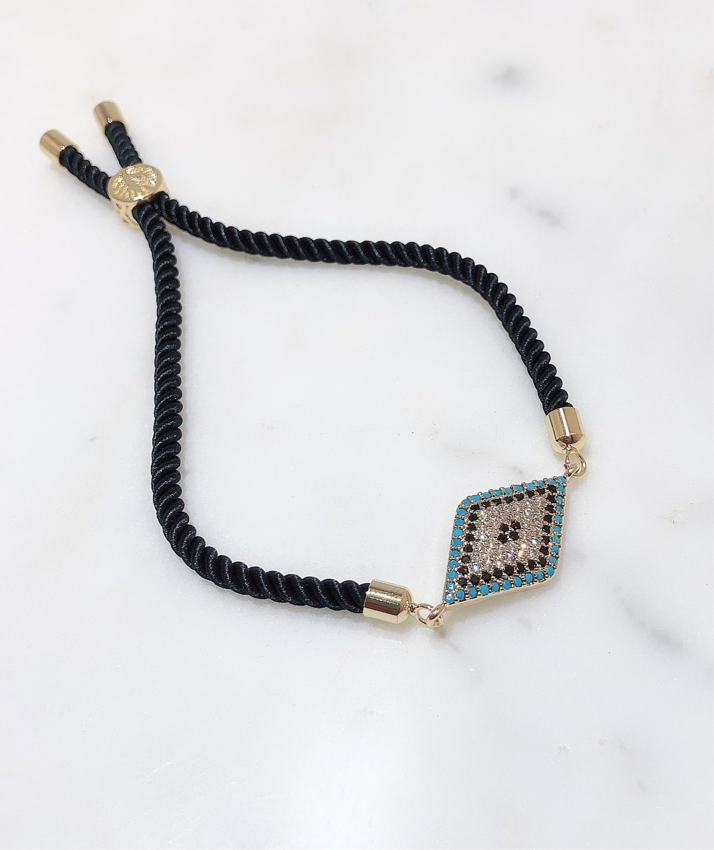 Diamond Crusted Gold Evil Eye Rakhi With Adjustable String