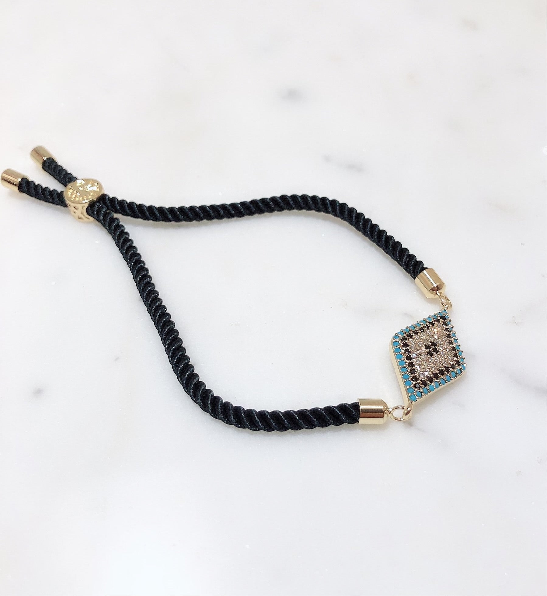 Diamond Crusted Gold Evil Eye Rakhi With Adjustable String